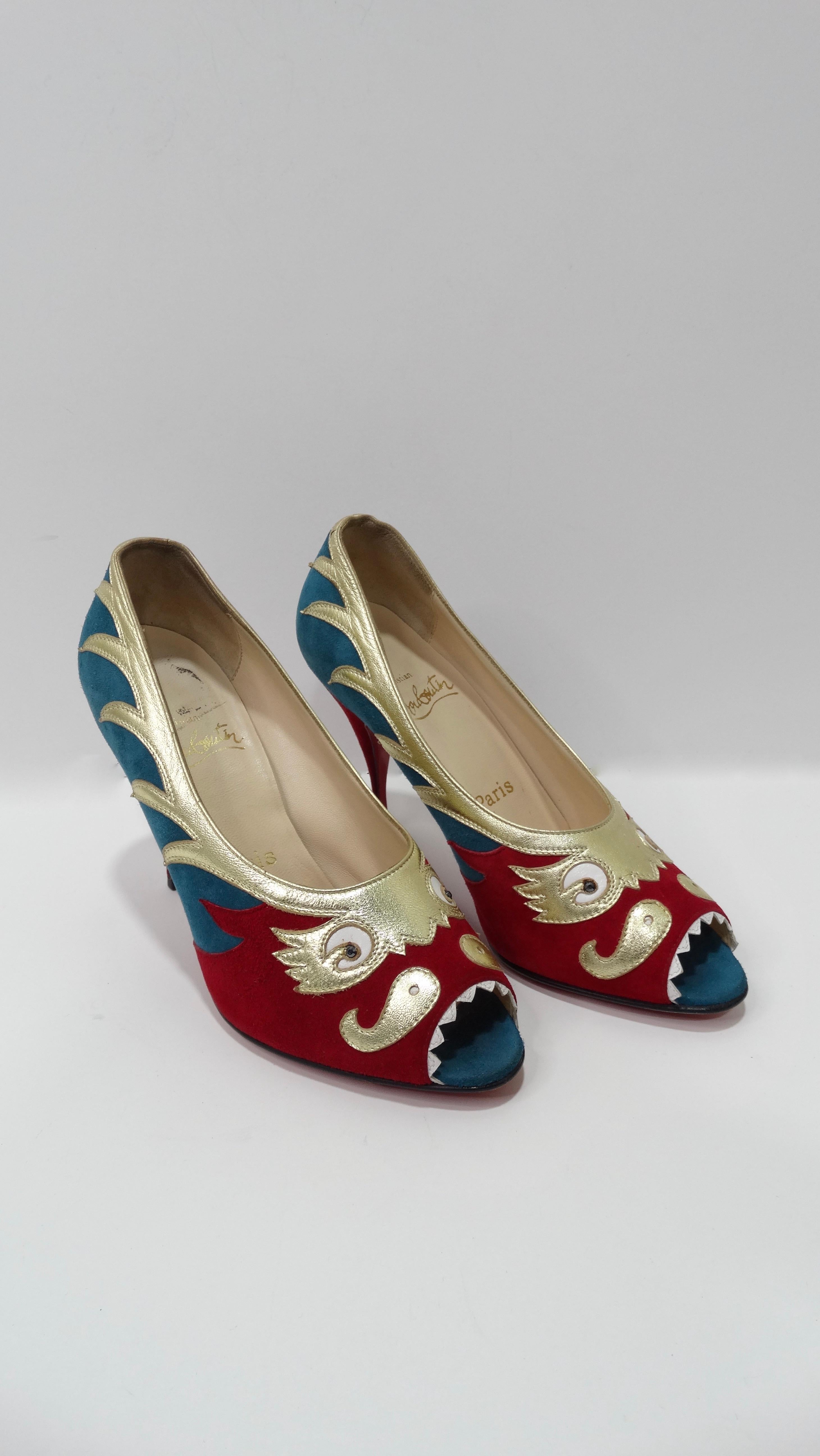 Elevate your look with these amazing Louboutin heels! Circa 2000s, these heels are crafted from teal/rich red suede and gold metallic leather to form a Chinese dragon motif. Dragon features black rhinestone eyes and white leather teeth that trim the