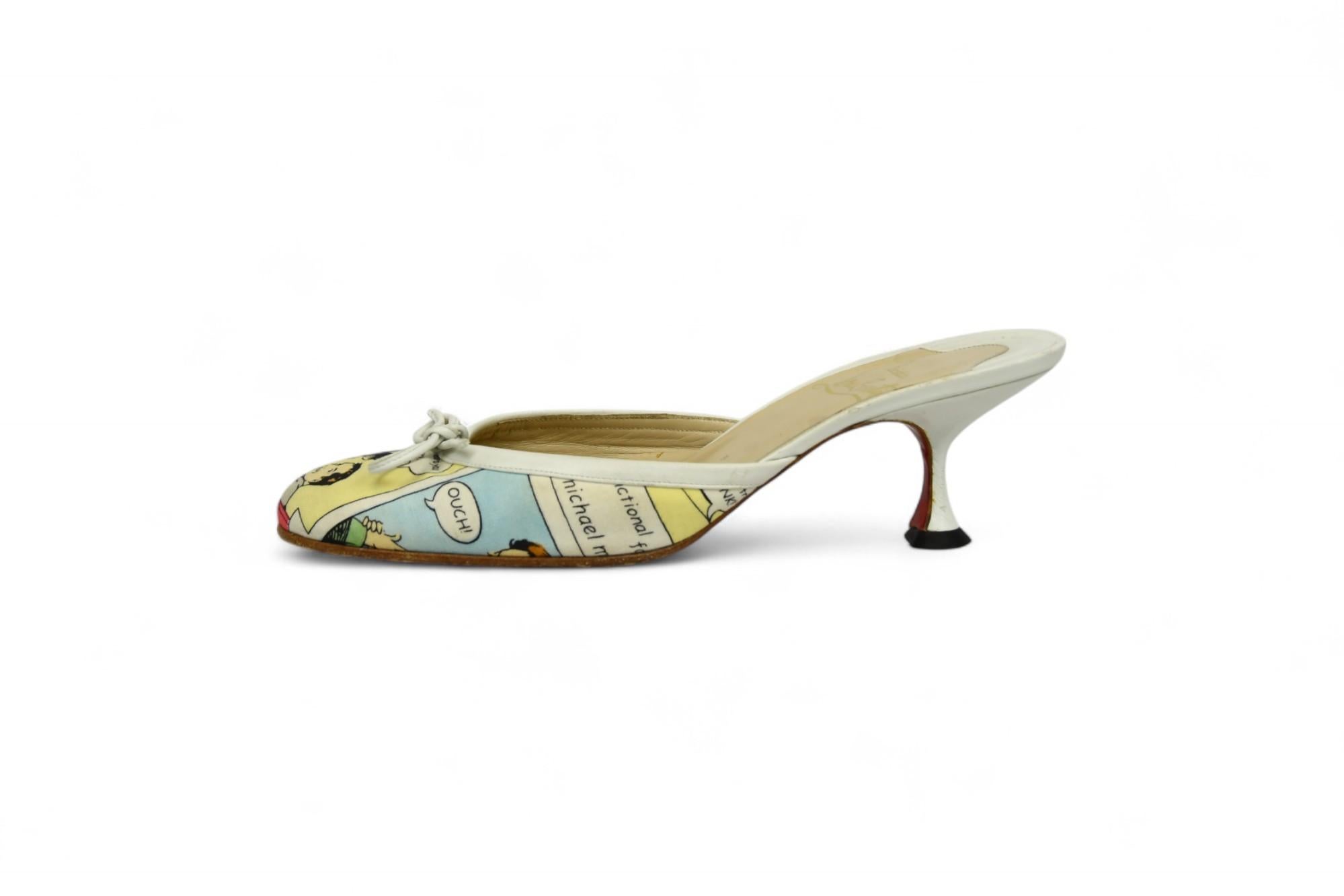 Playful and bold, these Christian Louboutin mules are a rare statement piece featuring a vibrant pop art comic print across canvas uppers. Trimmed in white leather and accented with delicate bows, they sit atop a sculptural kitten heel for an