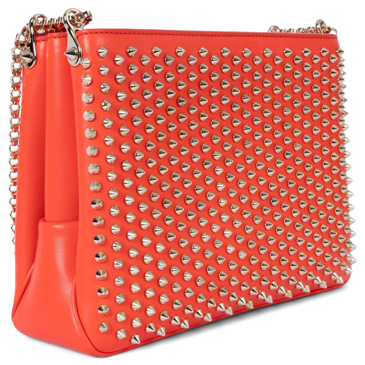 100% authentic Christian Louboutin 2016 Triloubi Large Spiked shoulder bag in capucine leather featuring gold-tone hardware. The design features three zipper compartments and is lined in red alcantara with one open pocket against the back. Brand new