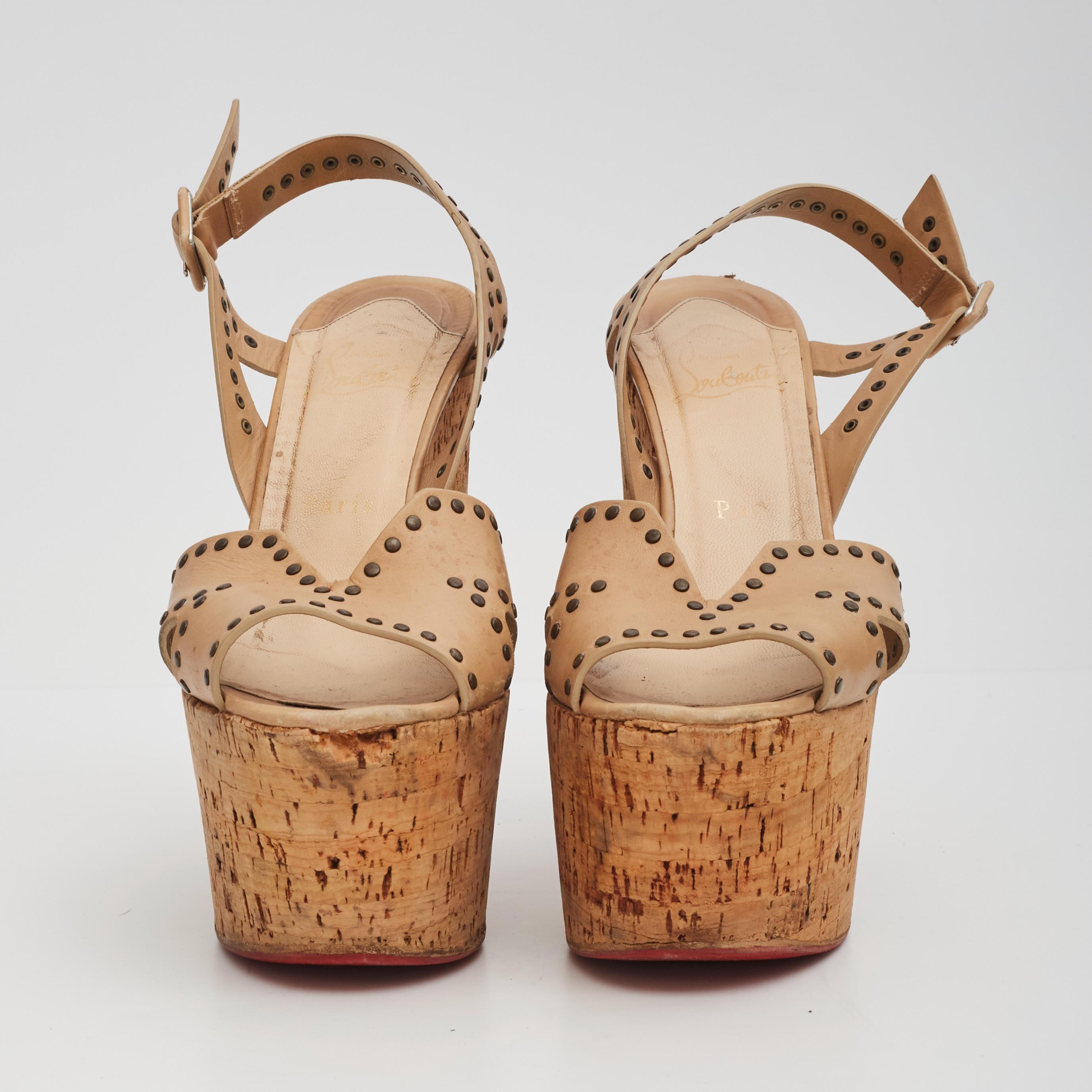 Color: Beige
Material: Cork wedge with leather studded straps
Size: 40 EU / 9 US
Heel Height: 140 mm / 5.5”
Platform Height: 63.2 mm / 2.5” 
Condition: Good. Wear includes scuffs, scrapes and stains to the outsoles. The tops show stains, marks and