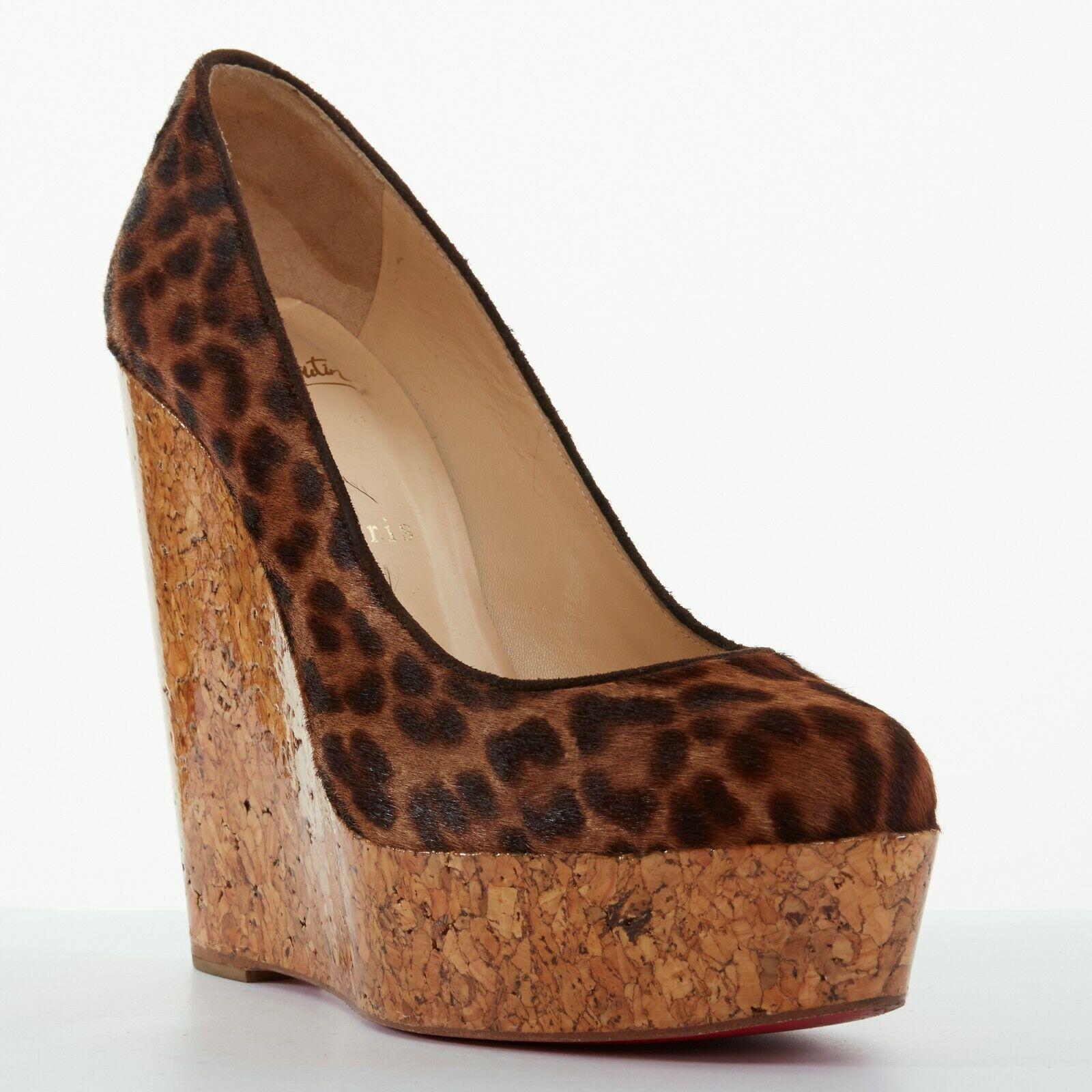 CHRISTIAN LOUBOUTIN Coroclic 140 leopard calf glossy cork wedge heels EU37.5
CHRISTIAN LOUBOUTIN
Coroclic 140. Brown leopard print calf leather upper. Dark brown suede trimming along opening. 
Almond round toe. Gloss lacquared cork wedge heel.