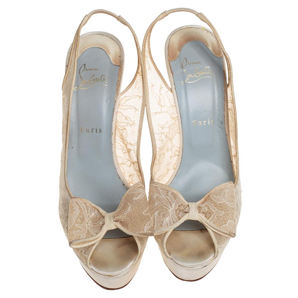 This pair of sandals by Christian Louboutin is a timeless classic. Step out in style while flaunting these amazing lace & suede shoes in cream, ideal for all occasions. They feature peep toes decked with a bow accent, slingbacks, platforms, and 14