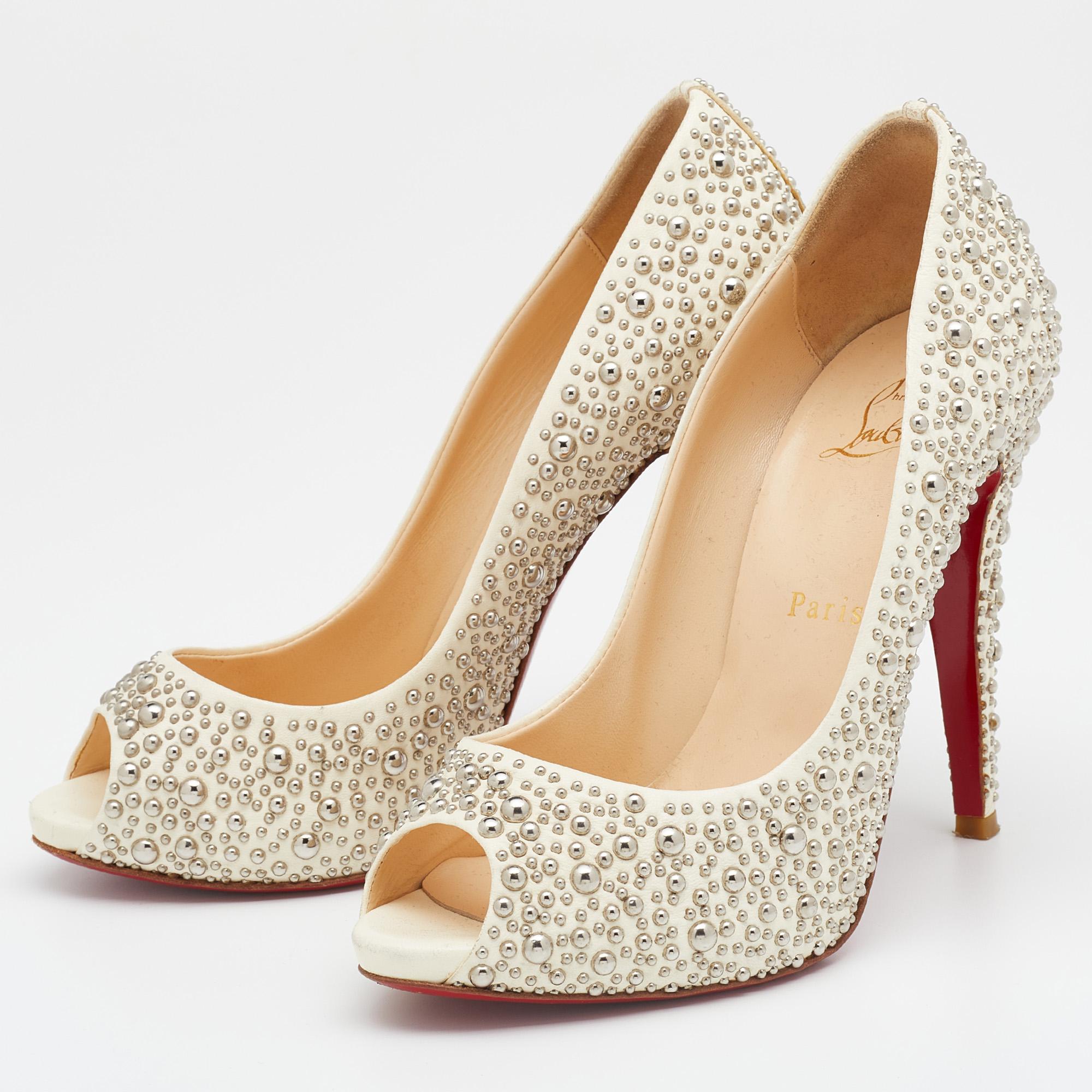 Covered in studs, these authentic Christian Louboutin pumps are meant to add a sophisticated finish to your look of the day. The designer pumps feature peep toes, leather lining, and 12 cm heels.

