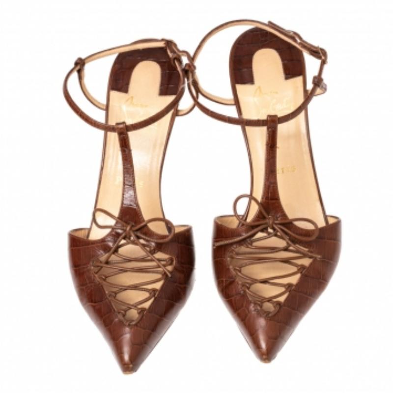 Finely crafted from brown croc-embossed leather in a T-strap style, these Christian Louboutin pumps will frame your feet beautifully. The sandals feature pointed toes, upper lace details, buckle ankle fastenings, and 8.5 cm heels.