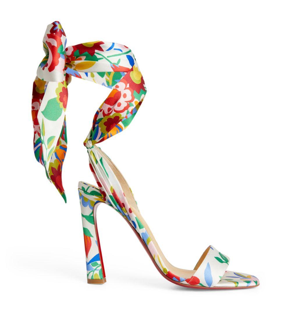 Christian Louboutin confectionne ces sandales blanches Crosse du Désert en cuir recouvert de satin de soie fleuri, agrémentées de liens à la cheville et d'un talon évasé.
