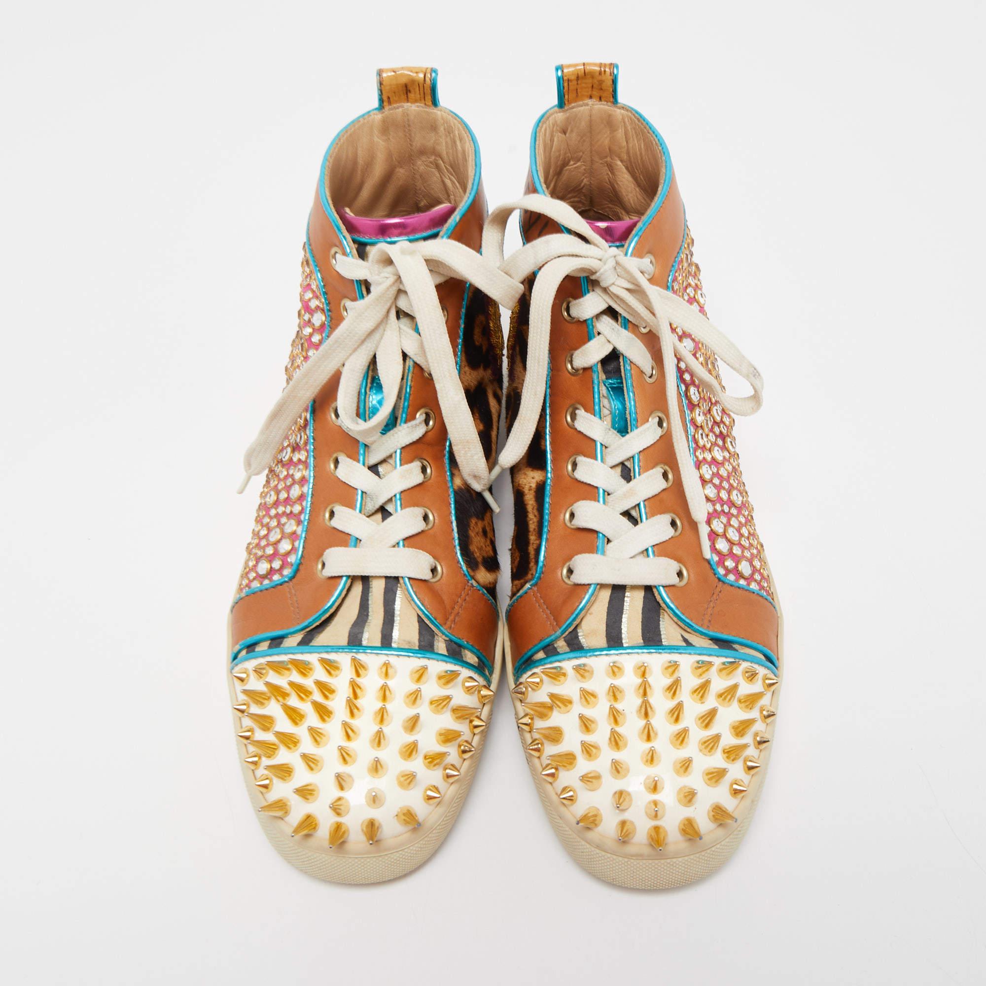 Nail your casual looks every time you step out in these sneakers from Christian Louboutin. They are covered in leopard-printed calfhair, suede as well as leather and styled with spikes and crystals. The sneakers are laced at the front and finished