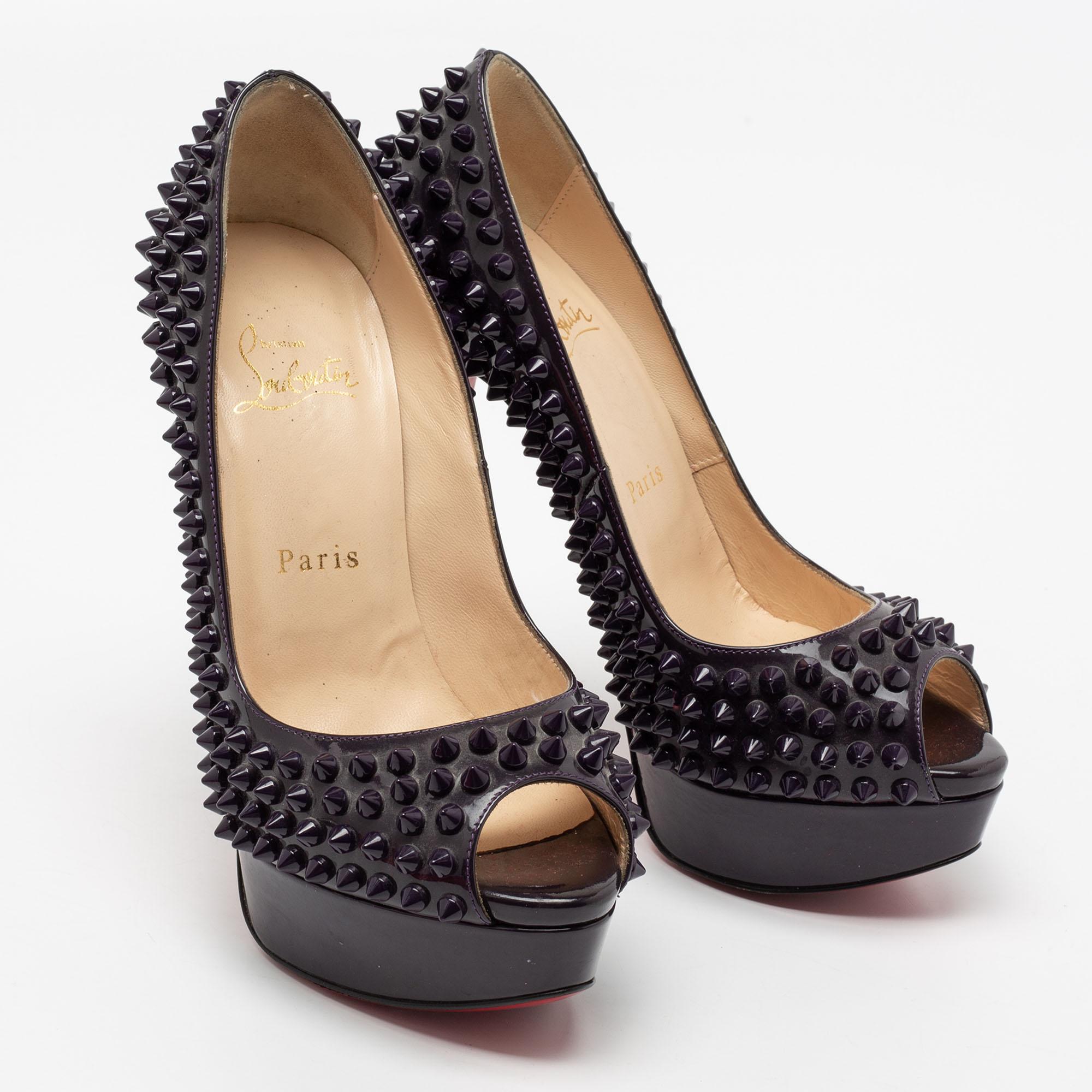 Stand out from the crowd with this gorgeous pair of Louboutins that exude high fashion with class! Crafted from patent leather, this is a creation from their Lady Peep collection. They feature peep toes and spikes all over the exterior. Completed