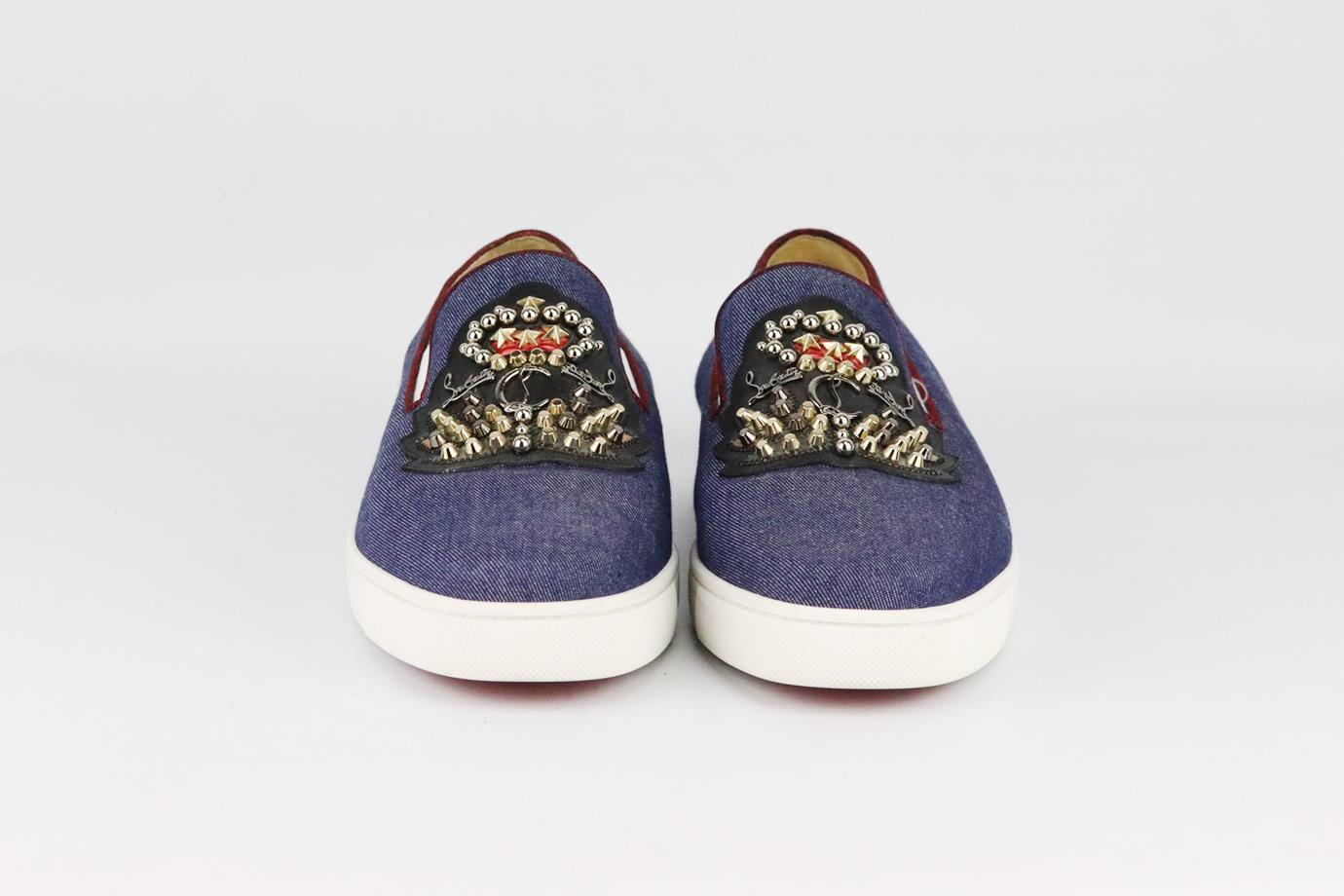 Christian Louboutin embellished denim slip on sneakers. Made from blue denim with logo embellishment on front and set on the brand’s iconic red sole. Blue. Slip on. Does not come with box or dustbag. Size: EU 43.5 (UK 9.5, US 10.5). Insole: 11.3 in.