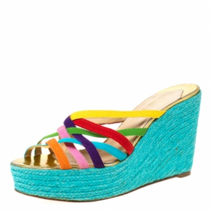 Absolutely on-trend and easy to flaunt, this pair of wedge sandals by Christian Louboutin is a true stunner. They've been styled with multicoloured crisscross fabric straps. They are complete with 10.5 cm espadrille wedges and the signature red