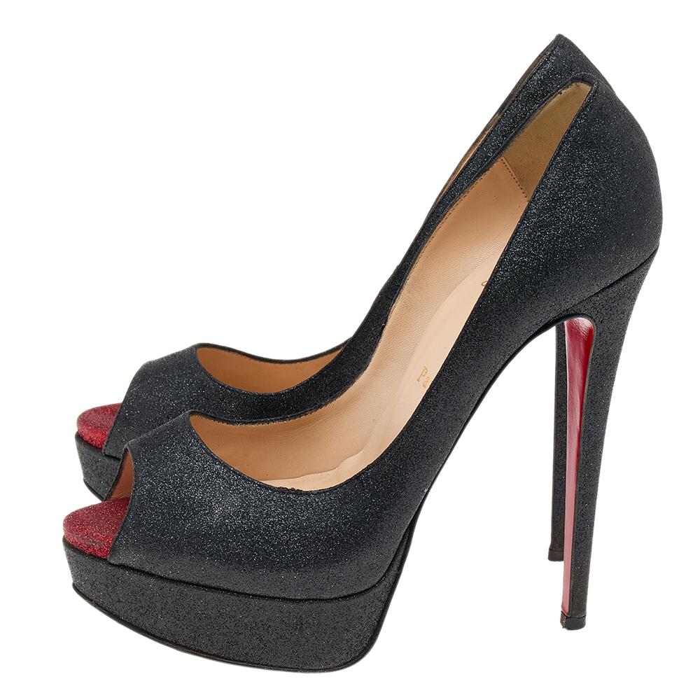 Glamorous and appealing in every detail, these New Very Prive pumps from Christian Louboutin will certainly leave you looking mesmerized and spectacular. They are made from black shimmer fabric and showcase peep-toes, platforms, and slim heels.