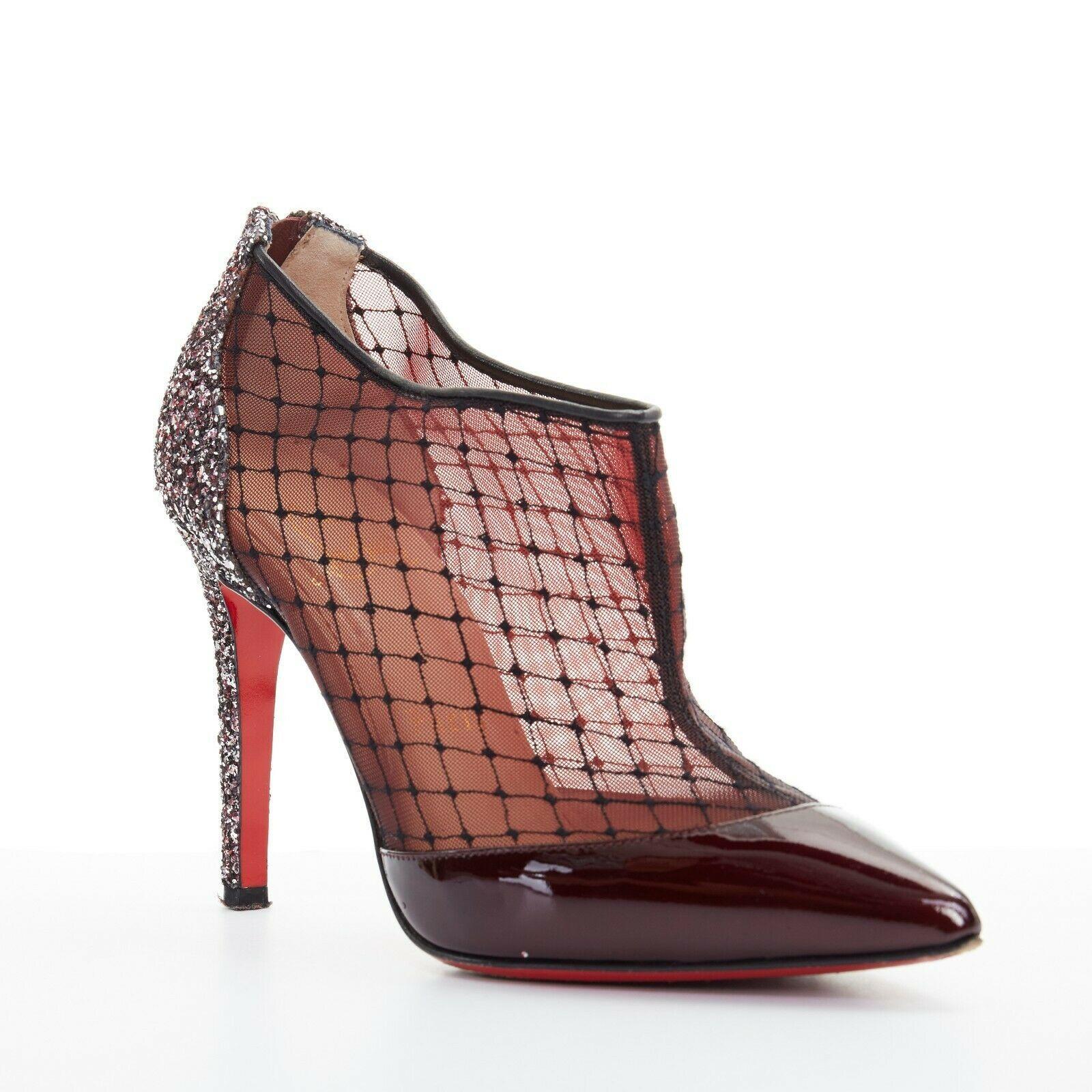 CHRISTIAN LOUBOUTIN Fillette 100 maroon patent mesh glitter heel bootie EU36
CHRISTIAN LOUBOUTIN
Fillette 100. Maroon dark red patent leather. 
Black fishnet embroidered mesh upper. Silver and burgundy glitter covered heel. 
Zip back closure. Tonal