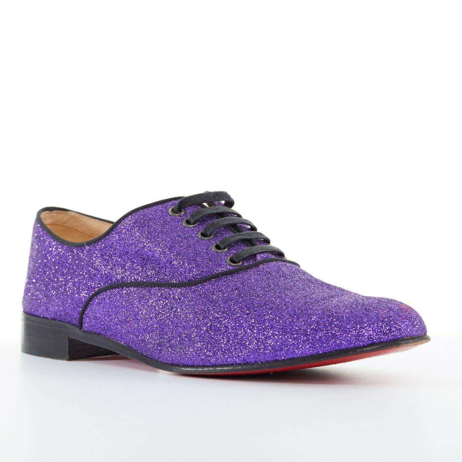 CHRISTIAN LOUBOUTIN Fred Flat purple glitter leather lace derby flat shoe EU37.5
CHRISTIAN LOUBOUTIN
Fred oxford flats. Purple fine glitter covered leather upper. Black grosgrain trimming. 
5-eyelet lace up front. Almond round toe. Black stacked
