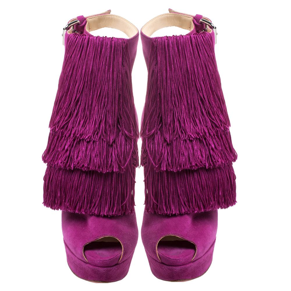 These stunning sandals from Christian Louboutin exude elegance and grace like no other! These fuchsia pink sandals come crafted from suede and flaunt swinging layered fringes at the front and crisscross straps with buckle fastenings at the ankles.