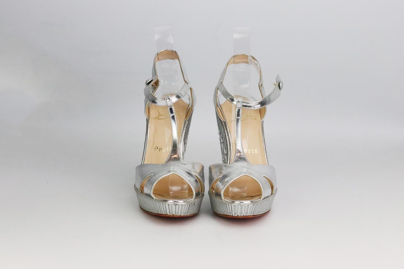 Christian Louboutin geometric leather wedge sandals. Made from silver leather with geometric design along the wedge with the brand’s iconic red sole. Silver. Button fastening at side. Does not come with box or dustbag. Size: EU 37 (UK 4, US 7).