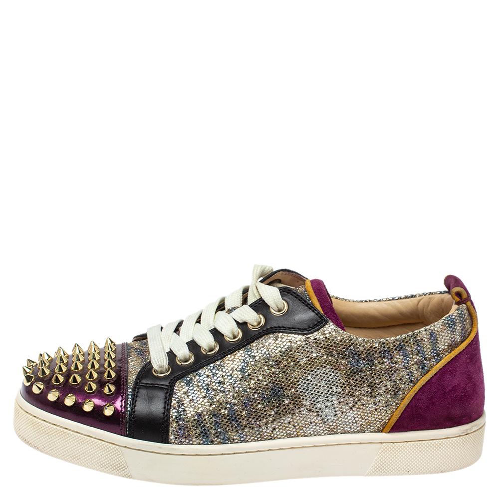 You'll leave your friends amazed every time you step out in these Louis Junior sneakers from Christian Louboutin! These sneakers are crafted from multicolor glitter and leather and feature round toes with multiple spikes detailed on them. They