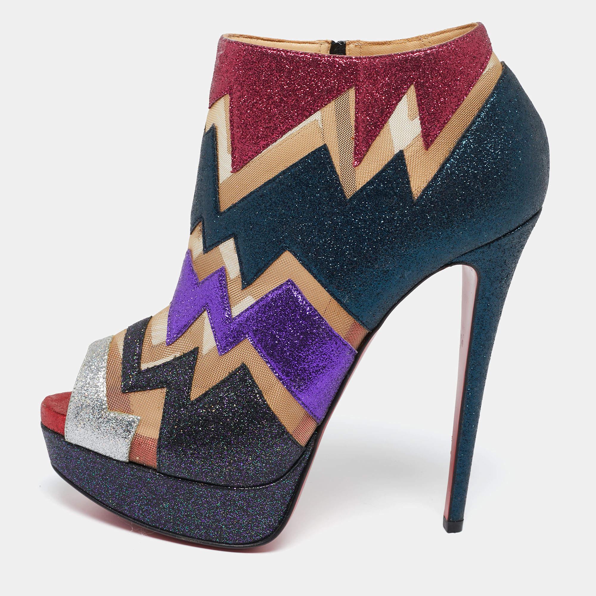 Take every step with confidence and panache in these stunning booties from the House of Christian Louboutin. They are styled using multicolored mesh and glitter on the exterior. They feature peep-toes, platforms, and tall 14.5 cm heels. These