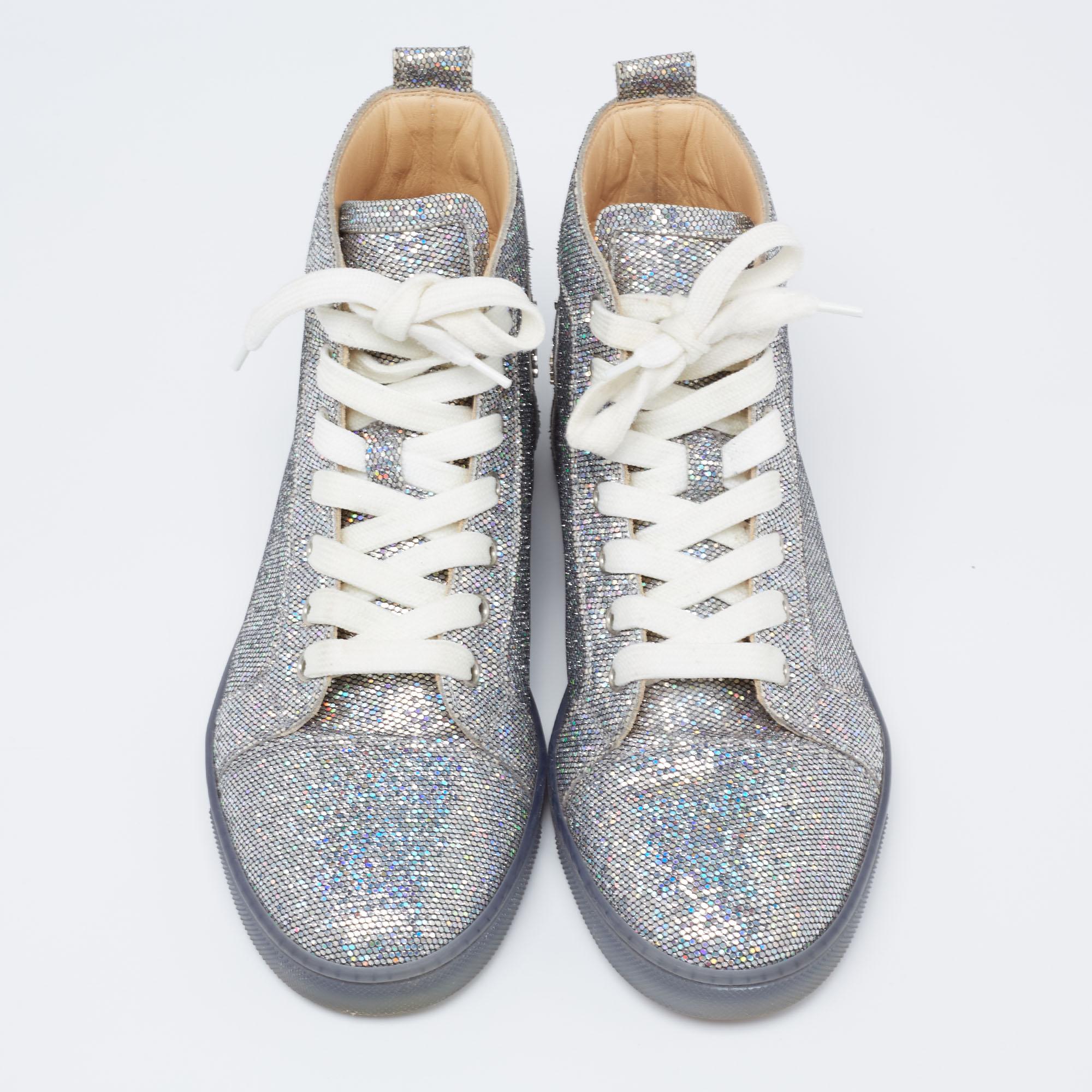Pull off a stylish look with ease in this pair of high top sneakers from Christian Louboutin. Crafted from glimmering silver glitter, this pair truly embodies luxury and comfort. They feature lace-ups, leather insoles, and durable rubber soles.

