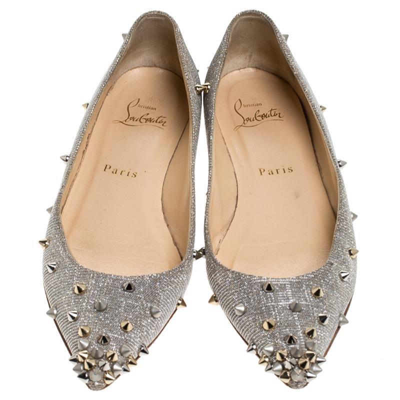 Be ready for constant attention and admirable gasps from your audience when you walk in these flats from Christian Louboutin. Crafted from metallic glitter fabric, they carry pointed toes and spikes decorated all over. The pair is complete with