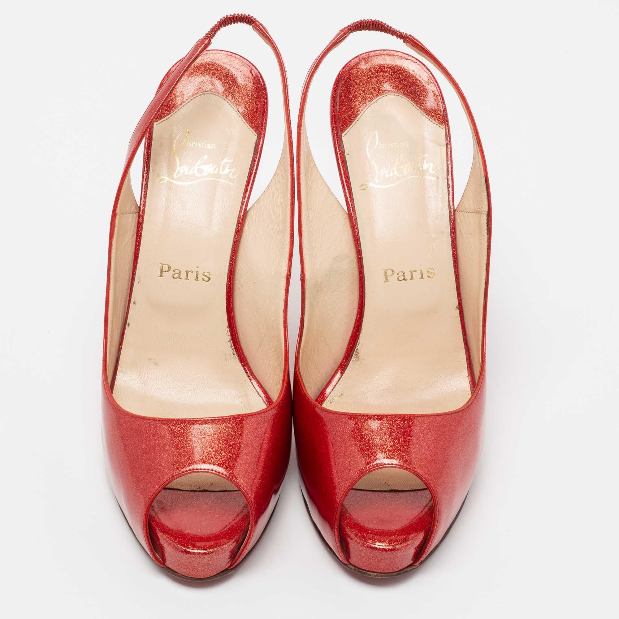 This pair of Christian Louboutin sandals is perfect for party nights. Step out in style while flaunting the glamorously red patent leather sandals. They feature a glittering exterior, peep toes, slingbacks, and 12 cm heels.

