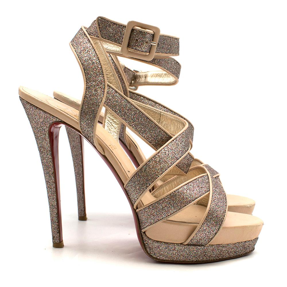 Christian Louboutin Glitter Straratata Strappy Platform Sandals

- heeled sandals
- stiletto heel
- platfrom 
- sparkle embellished leather
- wrap around ankle buckle fastening 
- nude leather insole
- iconic red leather outsole

Please note, these
