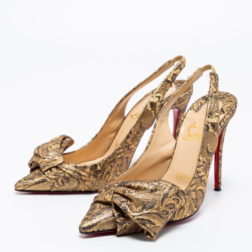This pair of sandals by Christian Louboutin is a stunning piece of art. Step out in style while flaunting these amazing brocade fabric shoes in gold, ideal for special occasions. They feature pointed toes decked with bow accents and have slingbacks