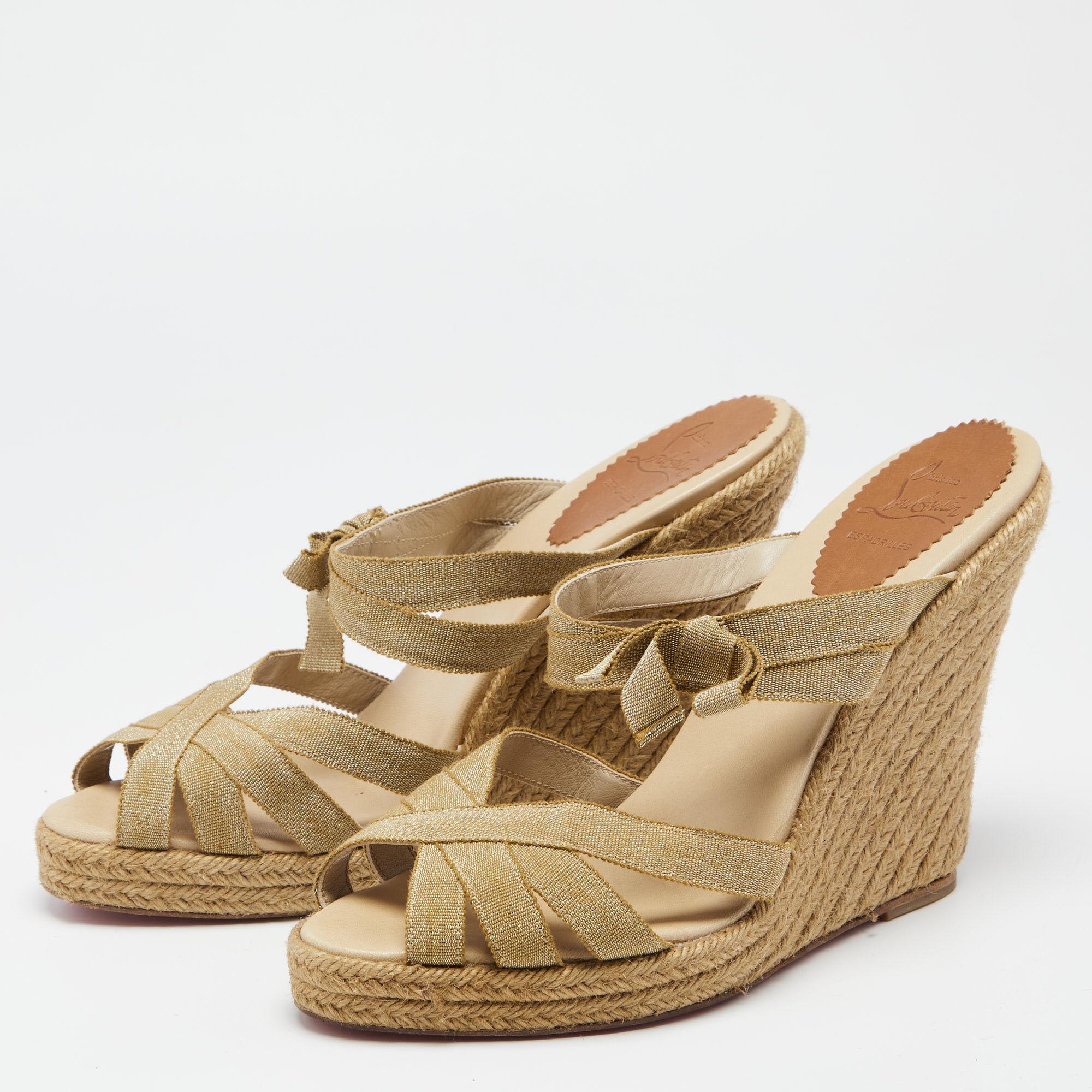 Christian Louboutin brings a perfect pair for the summer season! These sandals come with a gold-hued strappy upper that will frame your feet in the most elegant way. The espadrille wedge heels are supported by platforms for the comfort of your
