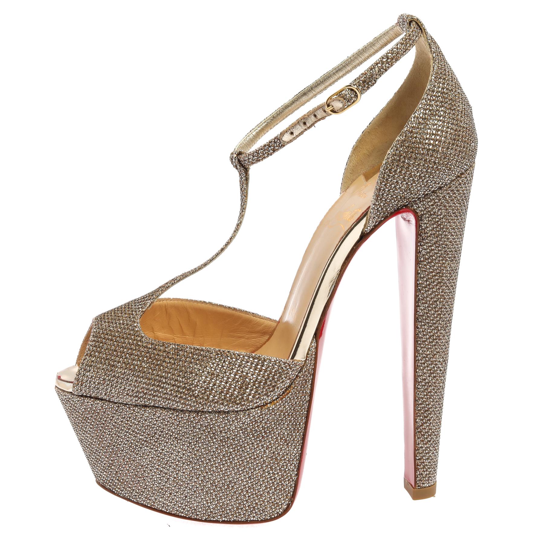 Give your footwear a glamorous makeover with these gorgeous pair from Christian Louboutin. This pair of glitter sandals stand tall on thin, tapered heels. The peep-toe front features a platform. The shoes feature a T-strap silhouette and an ankle