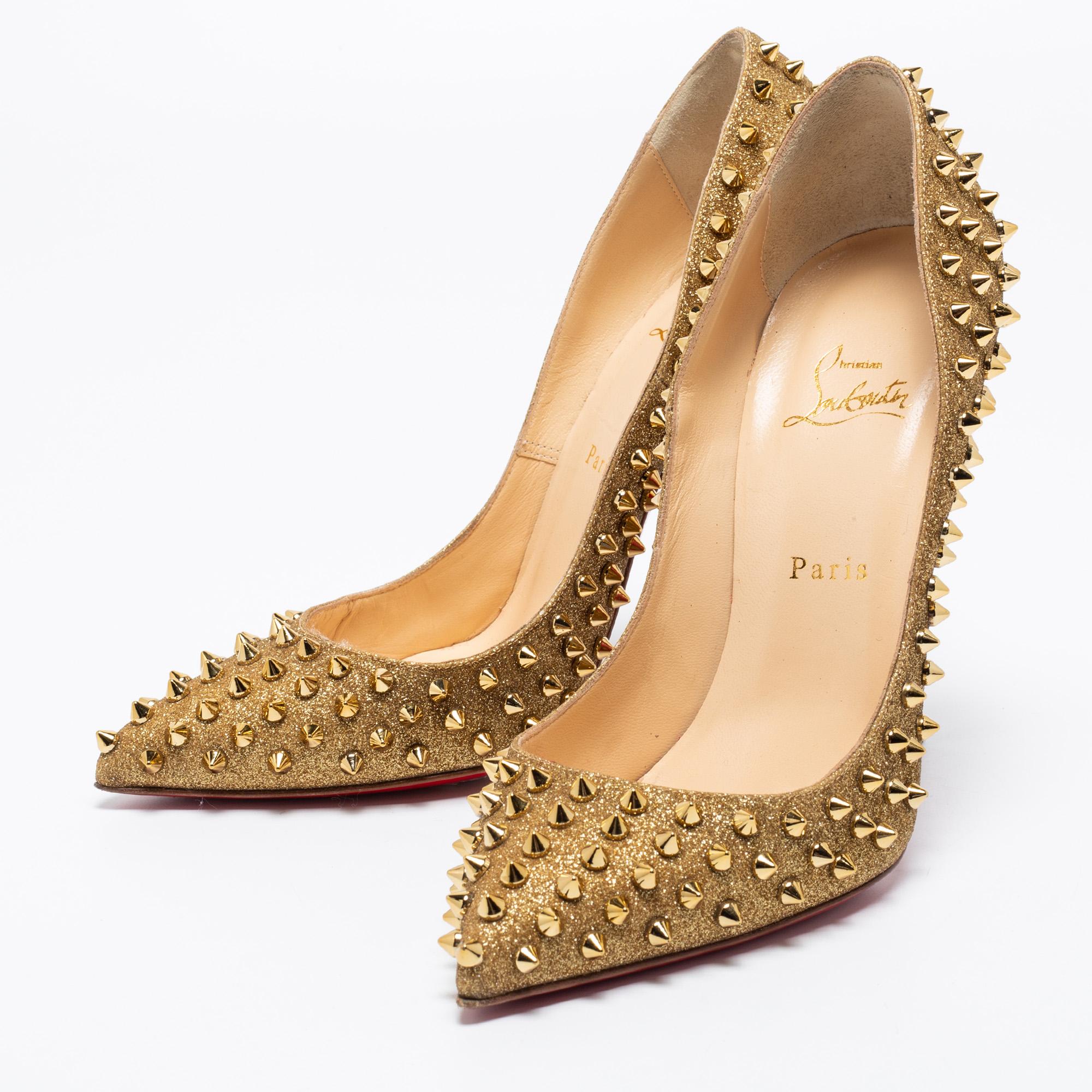 Amaze the crowds and make a statement like never before in these gorgeous pumps from Christian Louboutin! The gold-hued pumps have been covered using glitter into a pointed-toe style. They are exquisitely embellished with spikes on the exterior and
