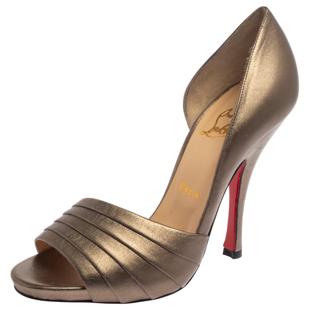 Gorgeous in gold, these pumps from Christian Louboutin are designed to help you make fashion statements time and again! They have been brought to life using leather into a peep-toe D'orsay silhouette and detailed with pleated vamp straps.