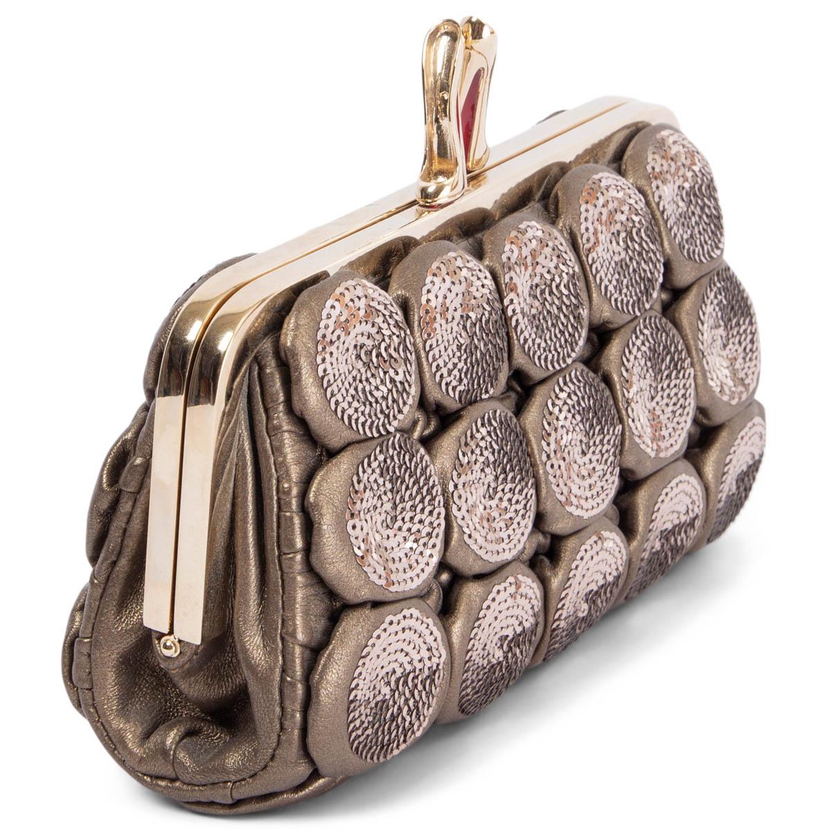 100% authentic Christian Louboutin clutch in metallic warm grey lambskin and sequins. Opens with a light gold-tone metal frame and signature high-heel clasp. Lined in red grosgrain fabric with one open pocket against the back. Has been carried and