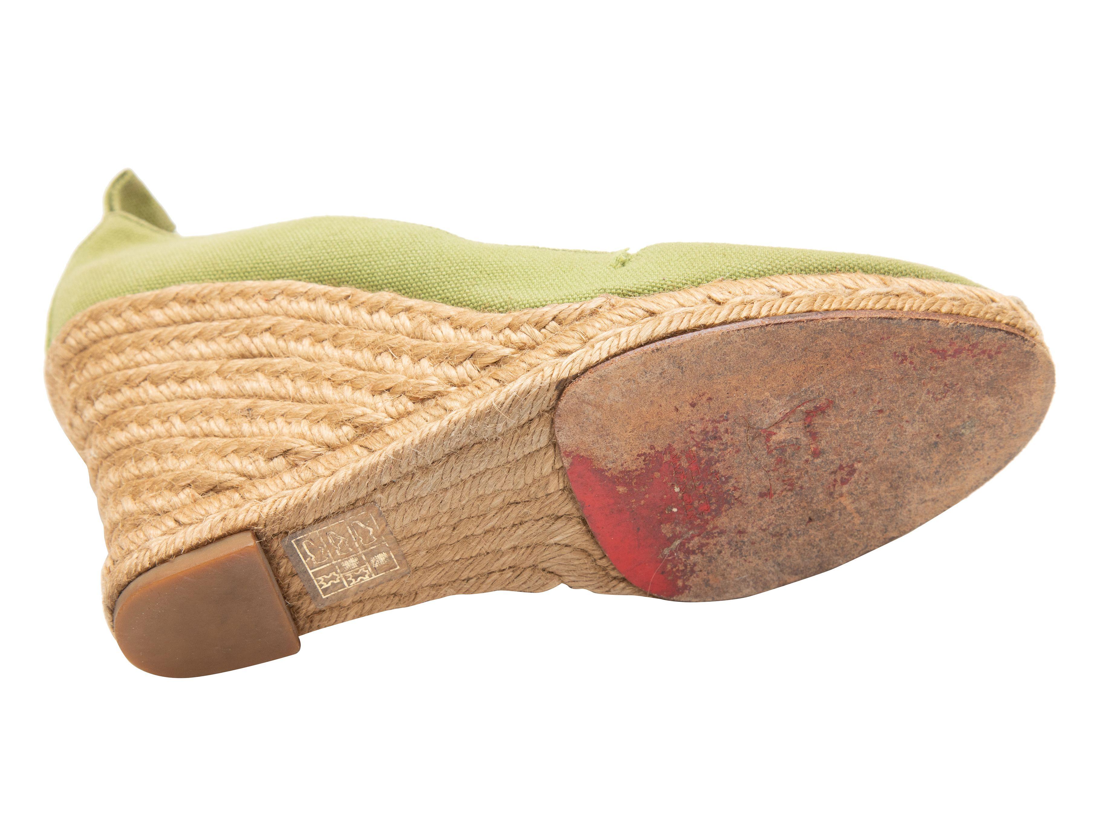 Product Details: Green and beige espadrille wedges by Christian Louboutin. Jute trim at soles. 3.5