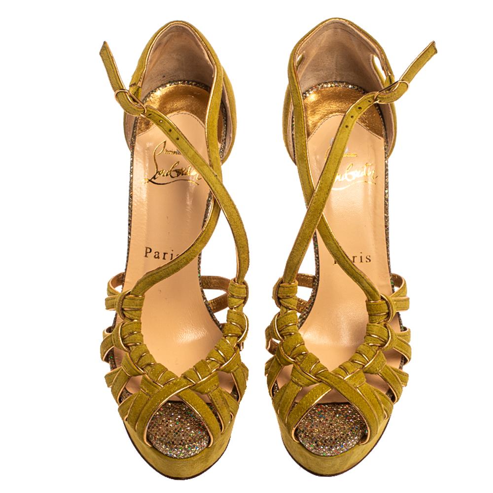 Pair your favorite outfits with these Louboutin sandals for a glamorous and stylish look. They come crafted from green suede and feature a peep-toe silhouette. They exhibit knotted vamp straps and buckled ankle straps and come endowed with