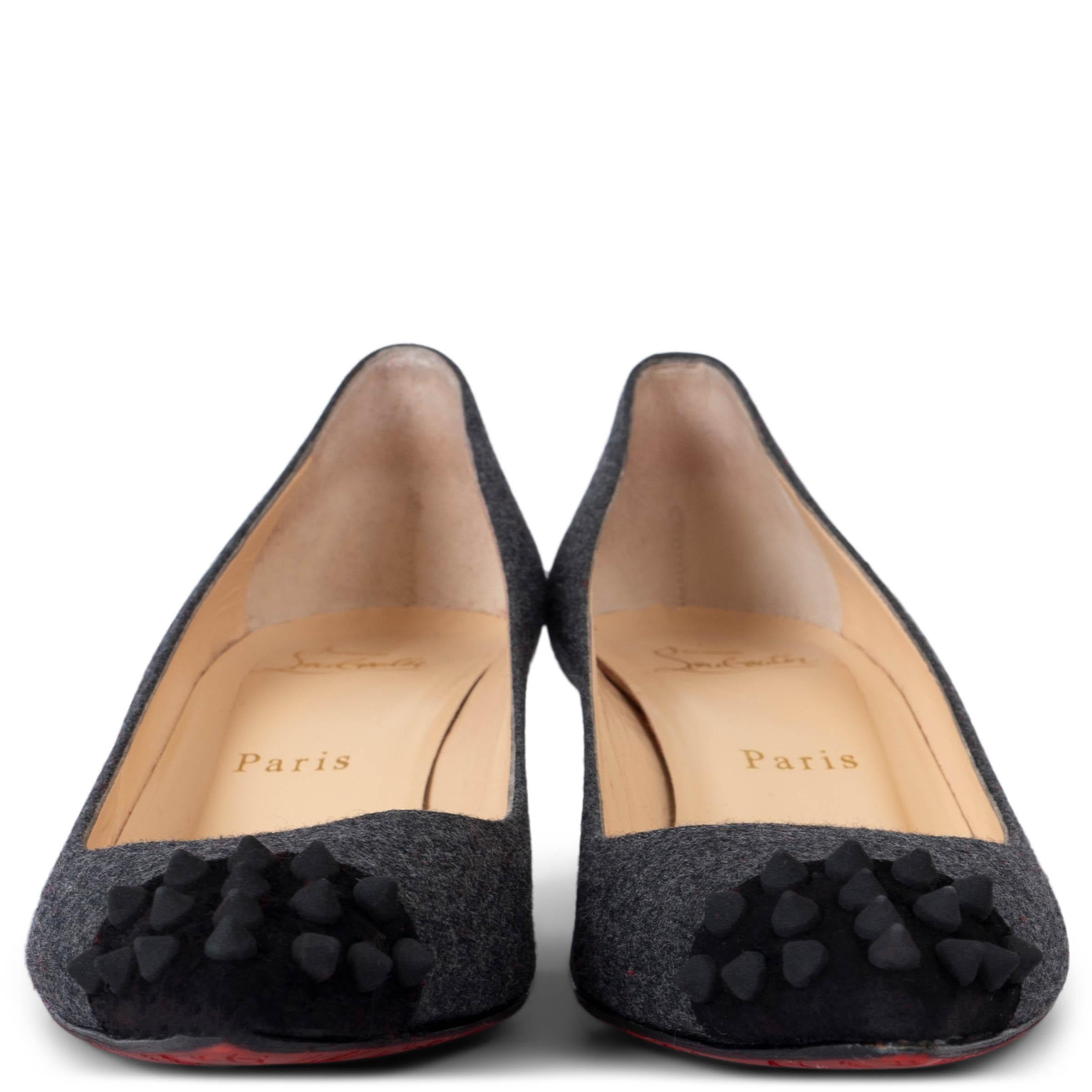 These 100% authentic Christian Louboutin Geo Flannel Kittenheel Pumps are crafted from luxurious grey wool, offering a chic yet edgy look. The pointed-toe design is elevated with black spike embellishments on the suede leather tip, adding a