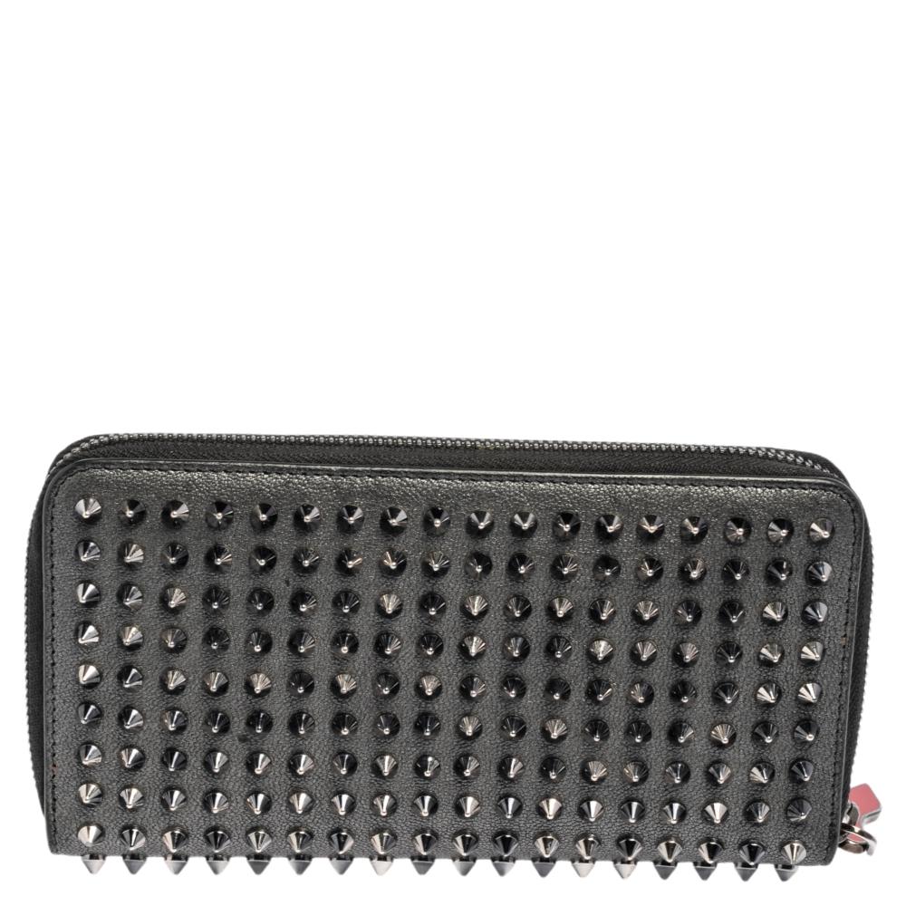 When you're not admiring the beauty of Louboutin heels, you've got to get your hands on this stunner of a wallet that is anything but ordinary! This grey wallet is crafted from leather and features spikes adorning the exterior. It flaunts a