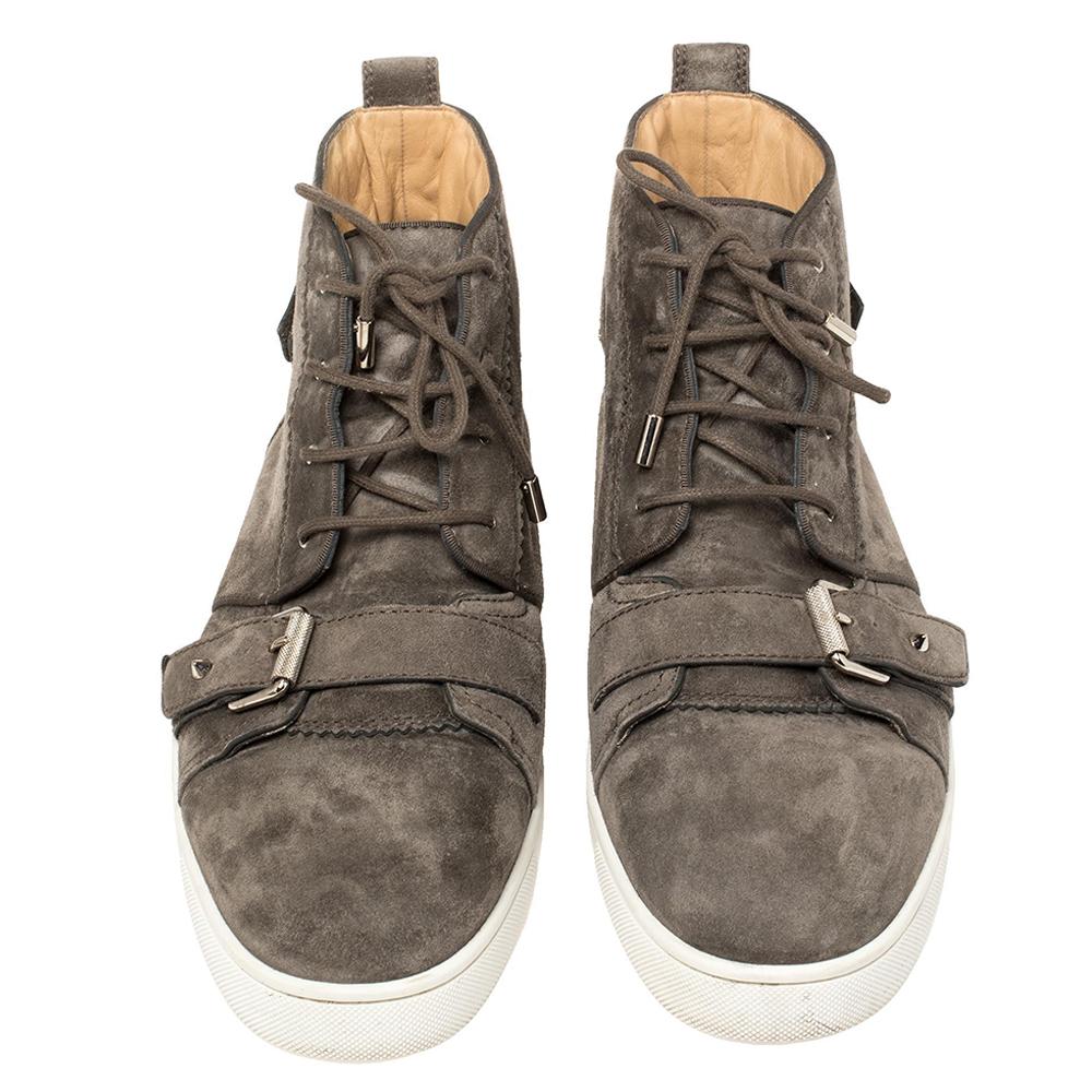 All the boldness and creativity of Christian Louboutin come together in these sneakers. They feature lace-ups, buckled straps and are set on rubber midsoles that sit above the house's signature red soles. These grey-hued suede sneakers are complete