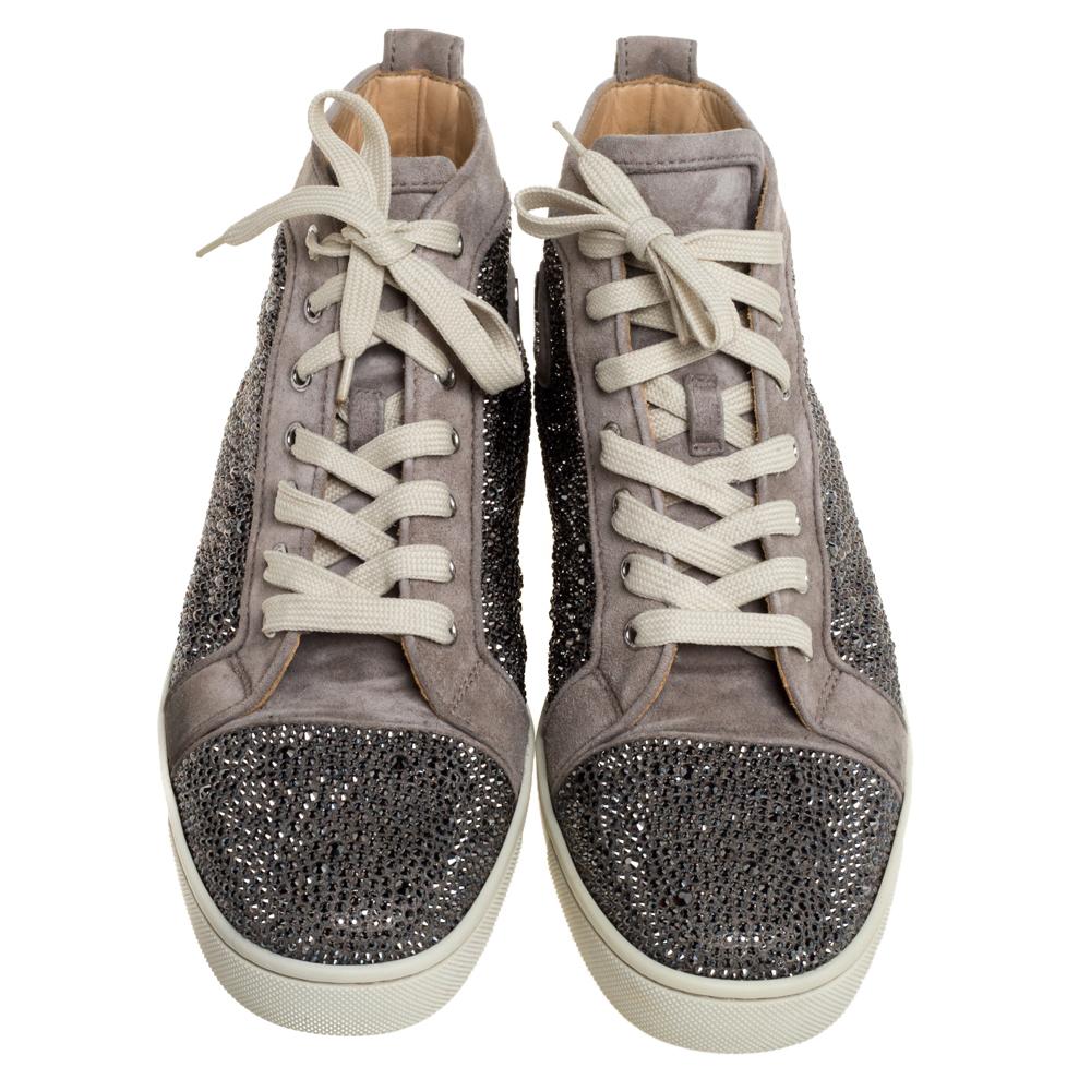You'll leave your friends amazed every time you step out in these Strass sneakers from Christian Louboutin! These sneakers are crafted from grey suede and feature round toes and an embellished exterior. They flaunt lace-ups on the vamps and come