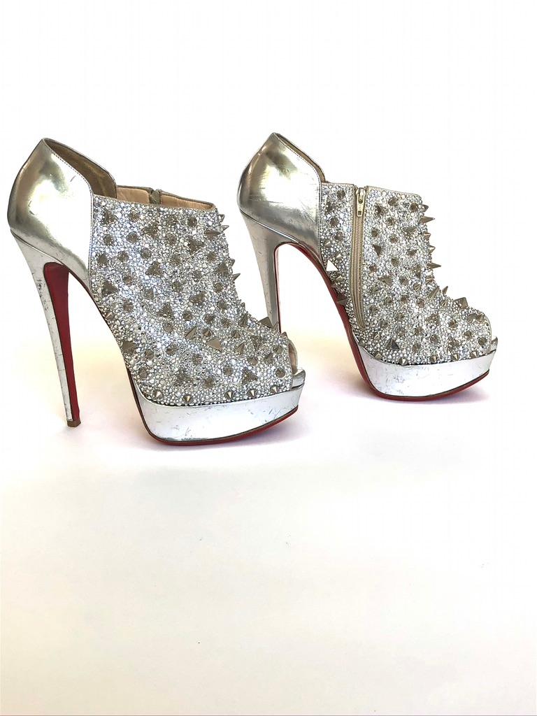 Metallic silver-tone leather peep-toe platform booties with spikes and crystal embellishments all over, covered heels and zip closure at sides. 
