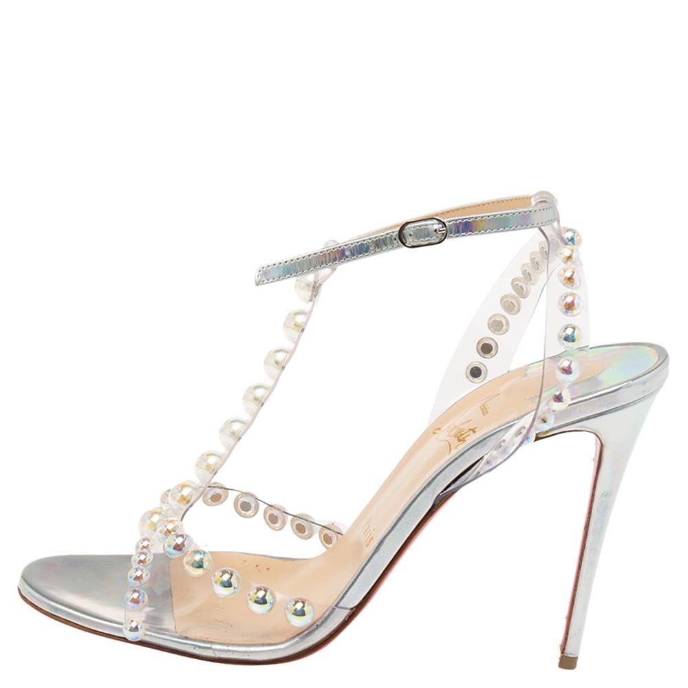 How stunning are these Christian Louboutin sandals crafted from iridescent leather and PVC! With their silver hue and studded, strappy silhouette, they are sure to win you compliments galore. They are finished with sturdy soles and slender heels.