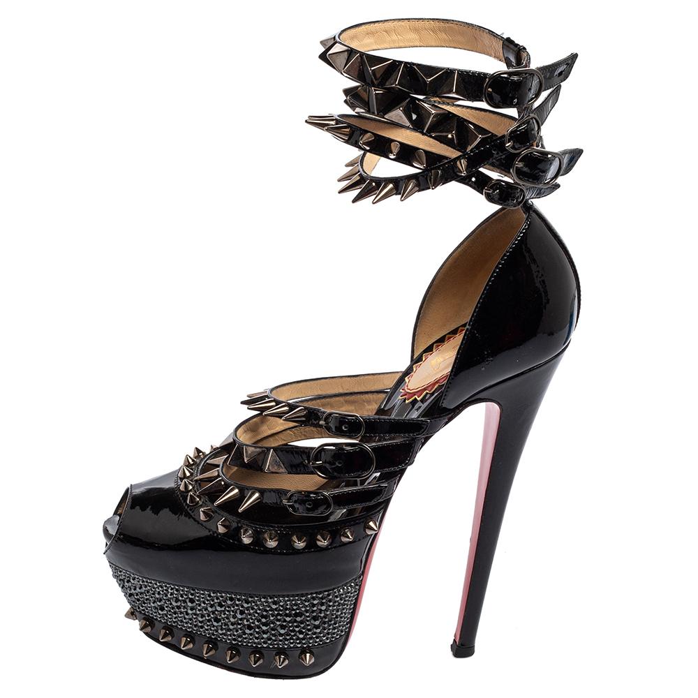Versatile and unique in every way, these 20th Anniversary Isolde sandals from Christian Louboutin will truly add charm and high fashion to your designer shoe collection. They are made from black patent leather and enhanced with spike embellishments.