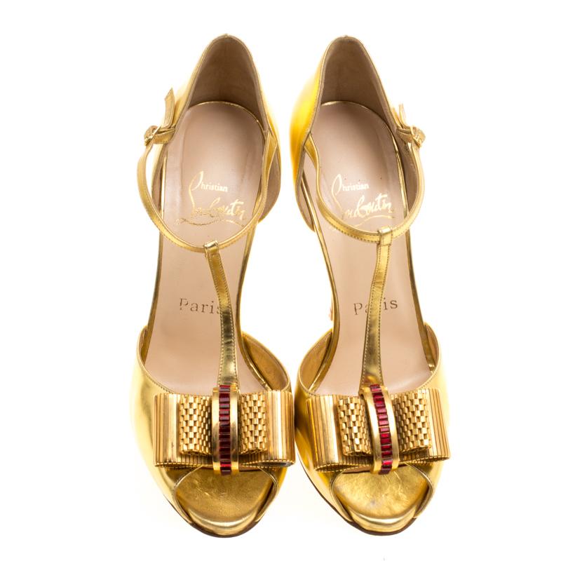 Spell-binding, aren't they! This metallic gold Louboutin is crafted in leather as a t-strap and designed with peep toes, double bow details and buckle closures at the ankles. The platforms, coupled with 11.5 cm heels make it a pair that's chic and