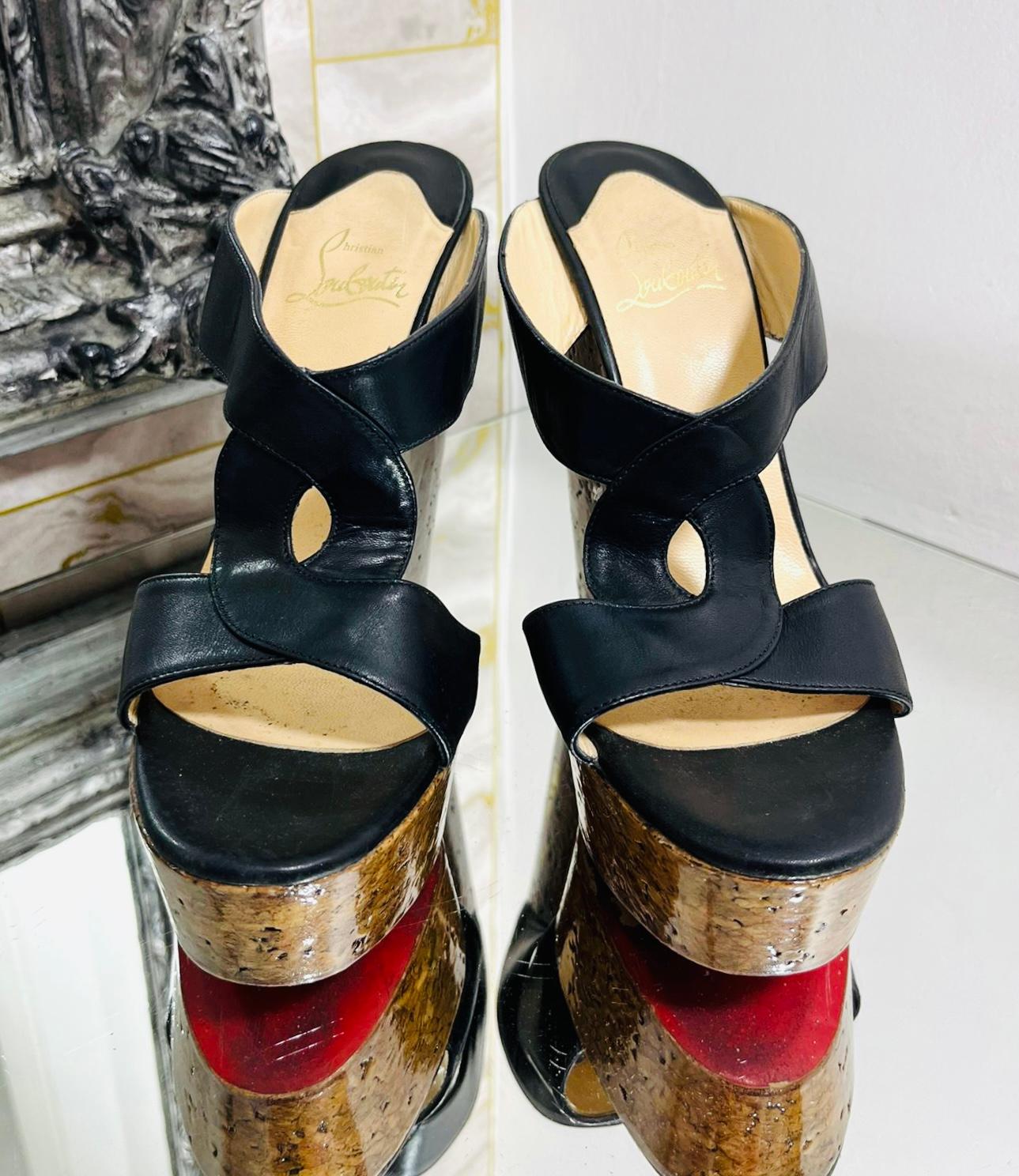 Christian Louboutin Leather & Cork Wedge Sandals

Black wedges designed with wide, twisted straps and detailed with high cork platform.

Featuring iconic red soles and leather lining.

Size – 38

Condition – Good (General signs of wear, scratches to