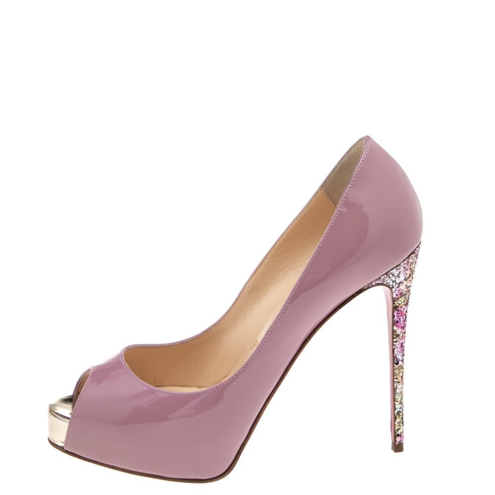 Glamorous and appealing, these New Very Prive pumps from Christian Louboutin will certainly leave you looking spectacular for the day. They are made from pink patent leather, with glitter heels elevating their beauty. They showcase peep-toes,