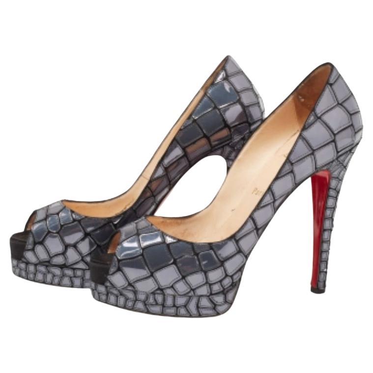 Here is a breathtaking pair of pumps known for its design and sophistication - the well-famed Mosaic 'Sobek' pumps crafted by Christian Louboutin. The exterior is crafted from patent leather and satin and the insoles are leather-lined for comfort.