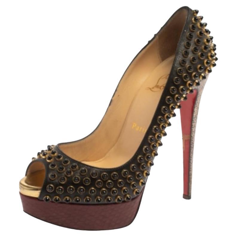 The striking design and enhanced comfort of these Christian Louboutin pumps make the pair a must-have. Crafted out of leather, snakeskin, and lizard, these pumps are styled with peep toes, beads, and high heels. Wear this fabulously-designed pair of