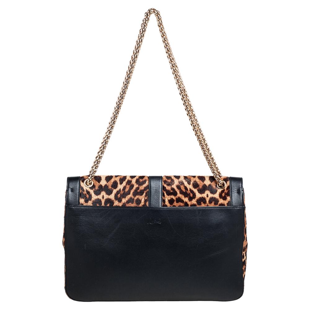 This modern and edgy Sweet Charity bag is from Christian Louboutin. Crafted from leopard-printed calf hair and leather, the bag comes with the signature Loubi bow detail. The insides are canvas-lined and the bag is complete with a chain. Invest in