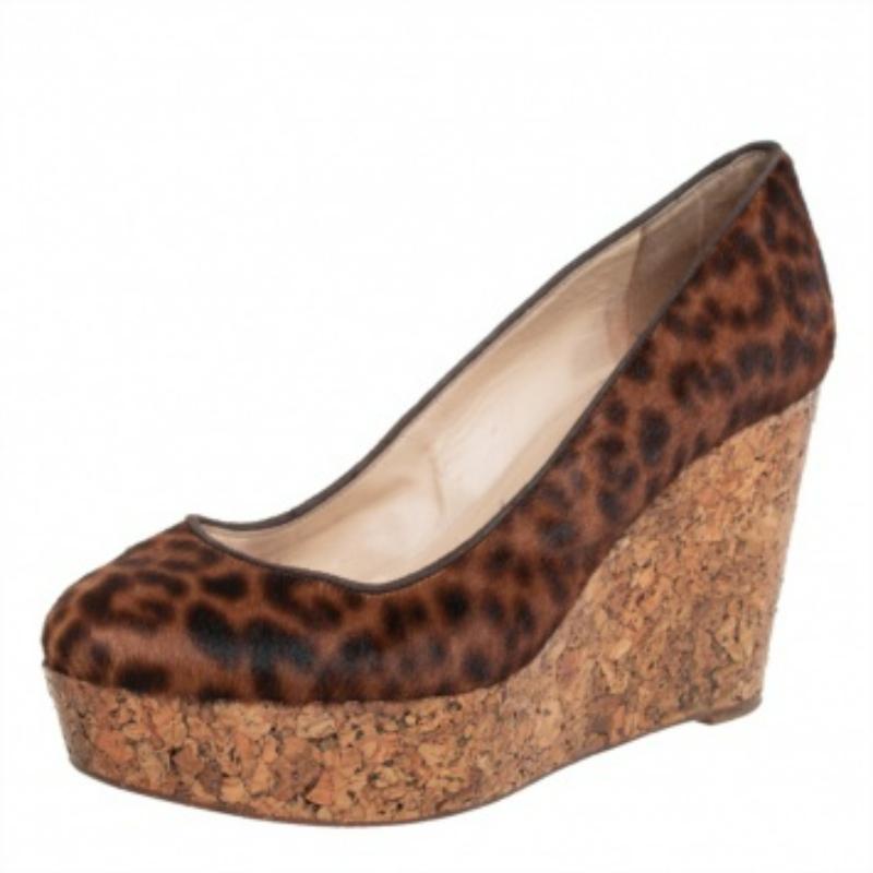 Look chic and make an elegant style statement in this pair of pumps from Christian Louboutin. They are crafted from leopard-printed pony hair and elevated on cork wedge heels. Be it with dresses or simple casuals, these pumps will appear lovely.