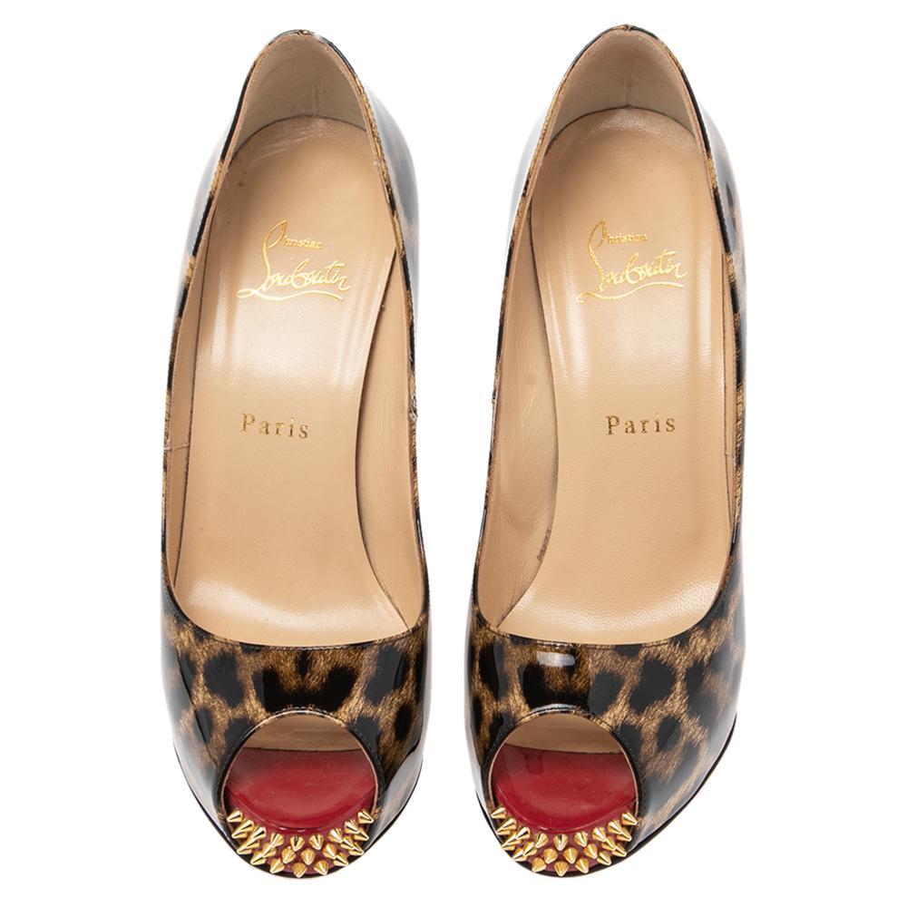 This pair of Christian Louboutin pumps is a timeless classic. Step out in style while flaunting these patent leather shoes, ideal for all occasions. They feature peep toes, spiked platforms, and heels. They are finished with the signature red