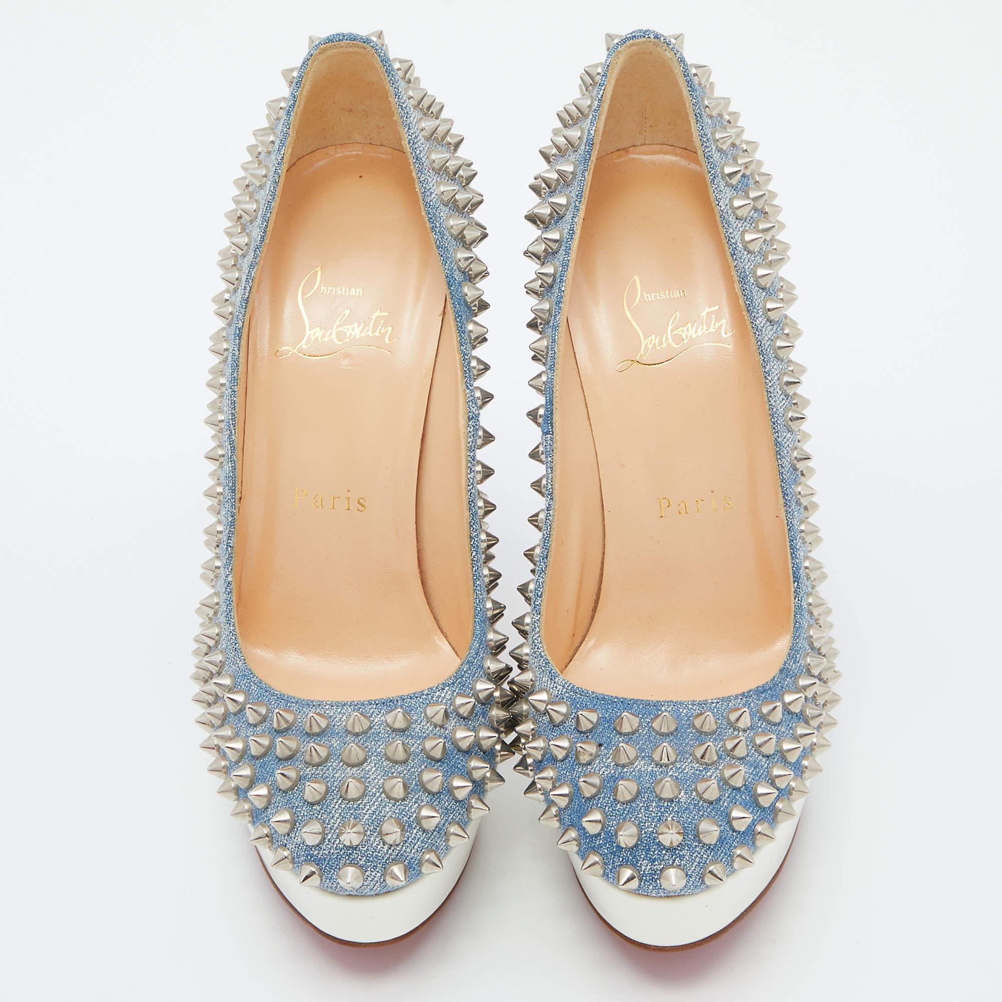 The Christian Louboutin pumps are a striking footwear choice. Made from light blue denim, these pumps feature the iconic red sole and are adorned with edgy silver spikes. They blend luxury and attitude, adding a touch of glamour to any