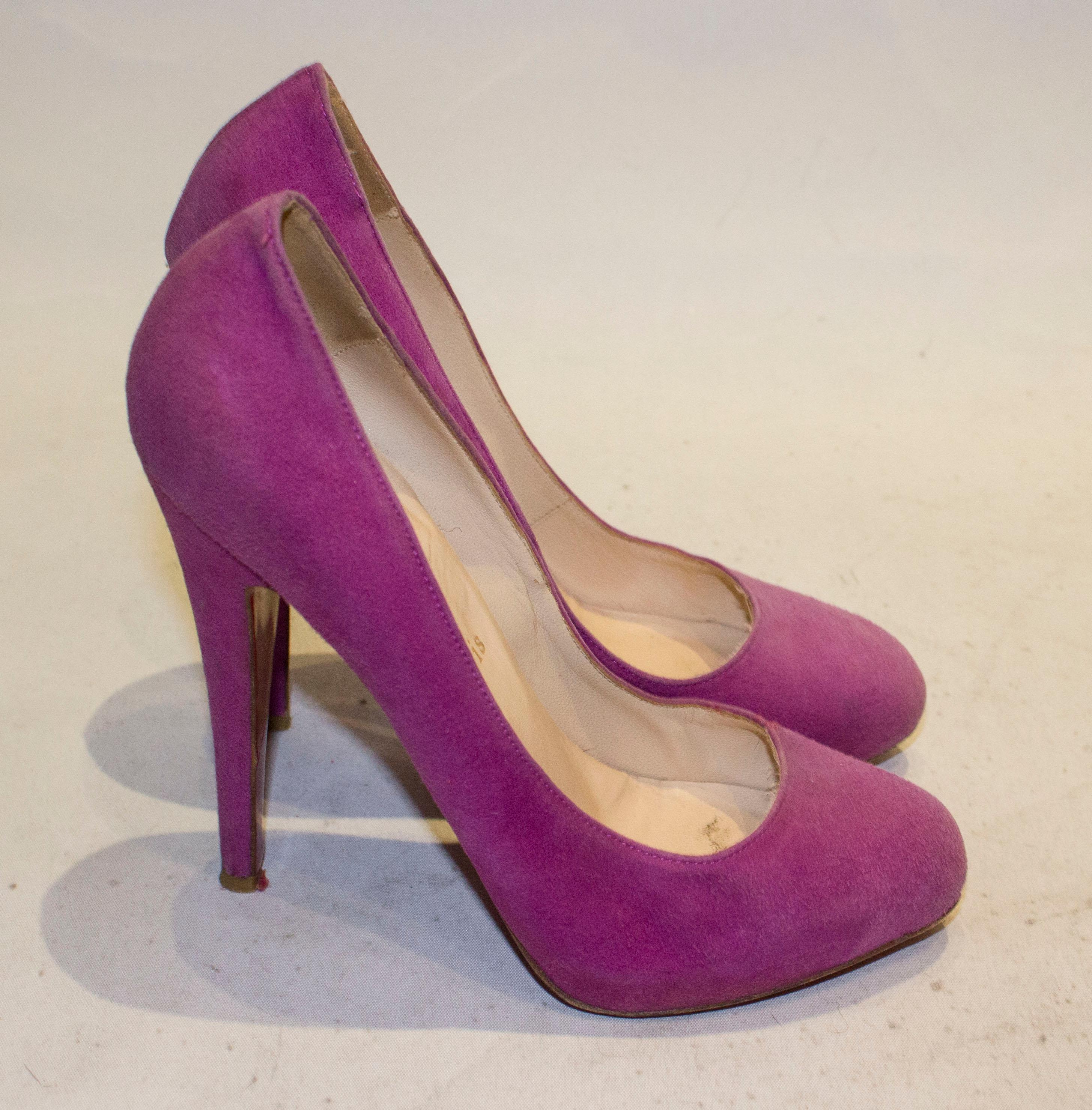 A pretty pair of lilac suede heels by Christian Louboutin. The shoes have a hidden platform and are marked size 38 1'2 , height 5 1/2''