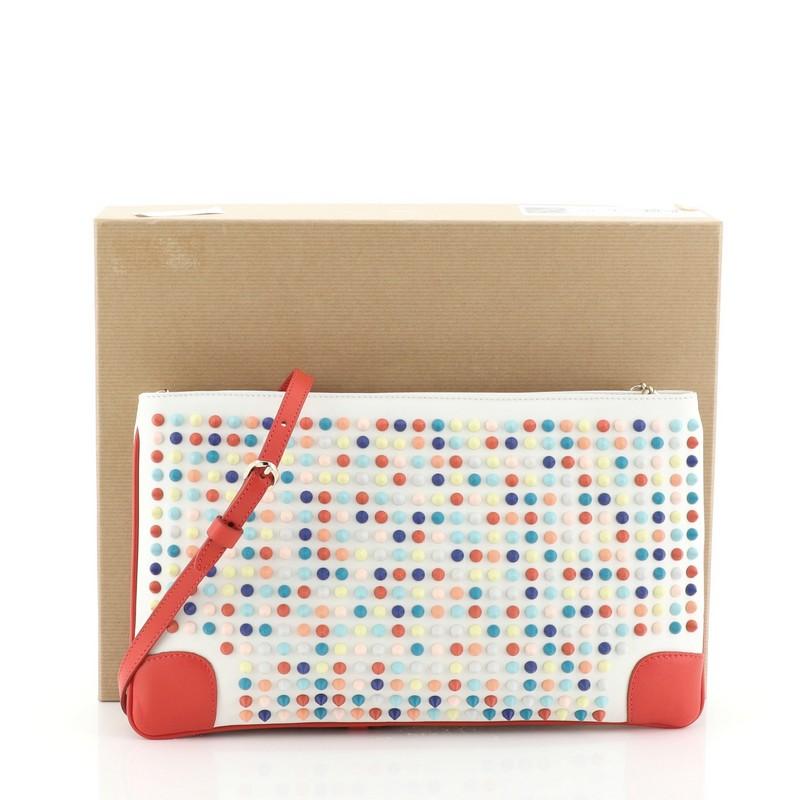 This Christian Louboutin Loubiposh Clutch Spiked Leather, crafted from white multicolor spiked leather, features a removable chain and leather shoulder strap, red enamel Louboutin logo zipper pull, and gold-tone hardware. Its zip closure opens to a